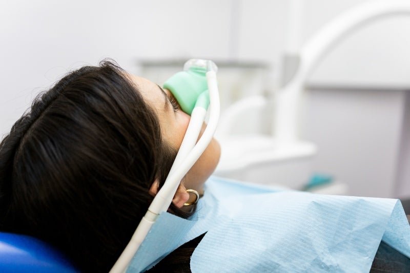 Woman wearing a nasal mask for oral sedation in Phoenix, AZ, dentistry