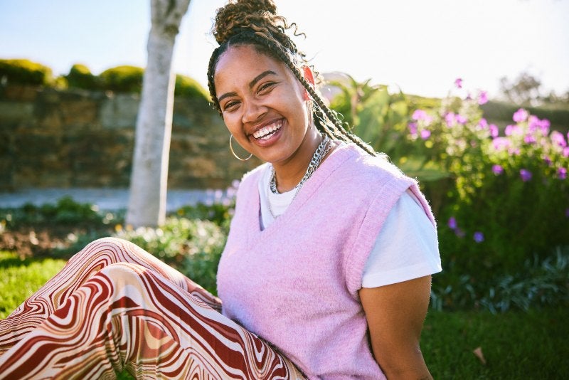 Smiling woman heading out of dentist clinic after getting restorative dental treatment in Phoenix