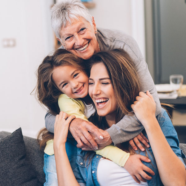 Young mother playing with kid & grandmother after successful teeth extraction procedure in Phoenix