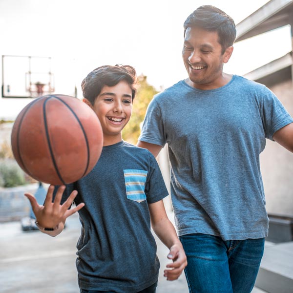 father and son playing basketball