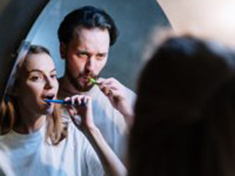 couple are brushing their teeth